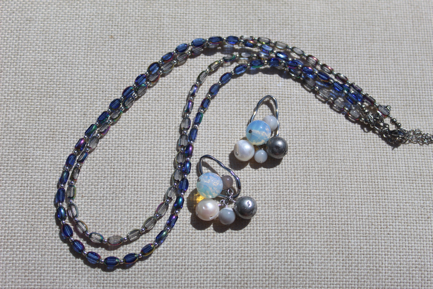 Baltic Bauble Earrings and matching Czech glass beaded necklace styled on linen with hematite, agate, pearl, and opalite stones