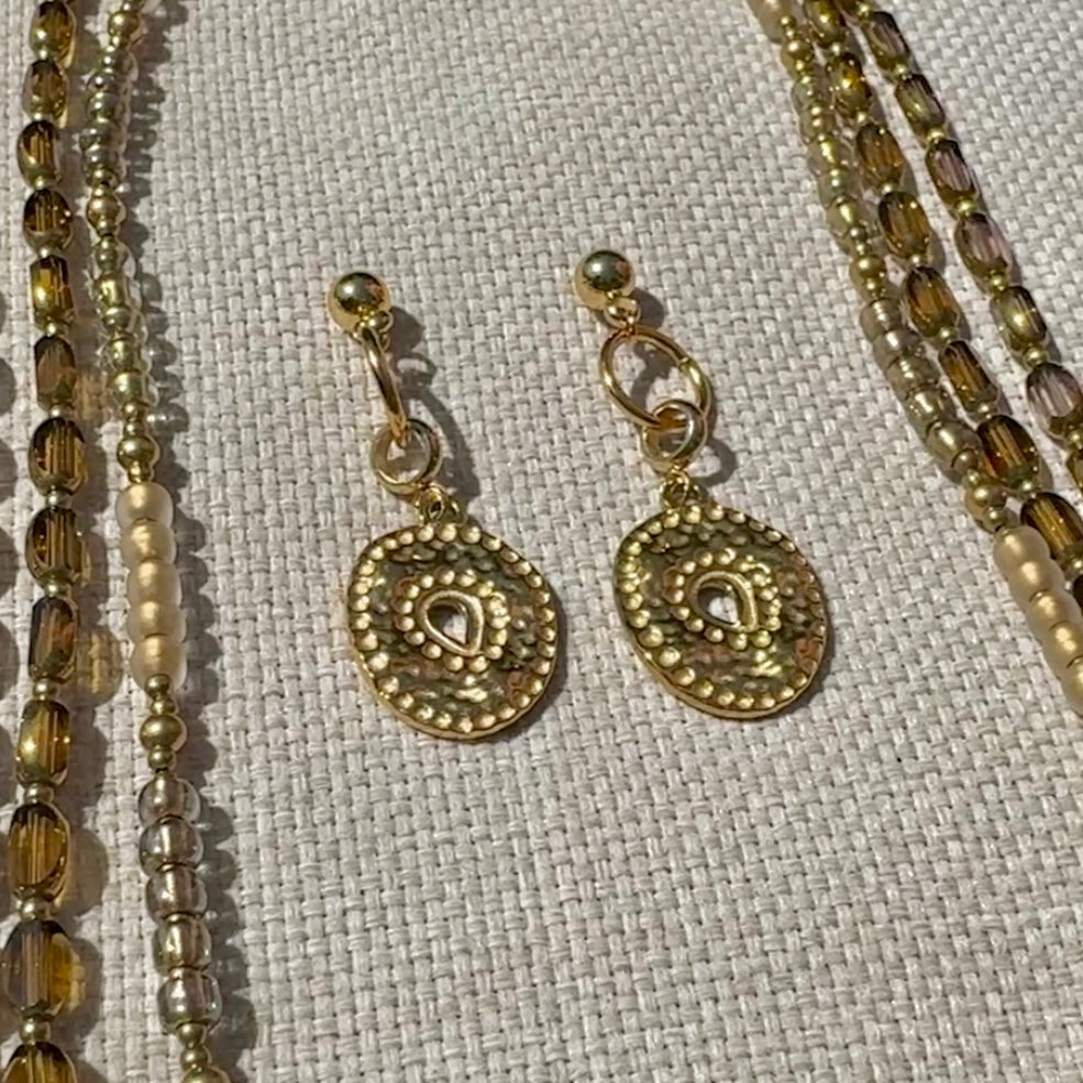 Golden Tide Earrings – 18K gold plated stainless steel charm earrings on textured linen background
