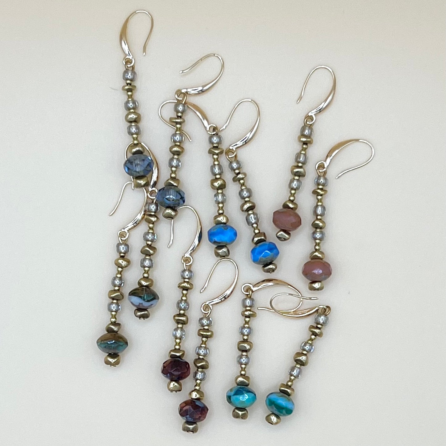 Group of May & Moon’s handmade Everything Earrings in assorted colors featuring fire-polished Czech glass beads, gold accents, and sterling silver ear wires — lightweight and perfect for gifting or layering.