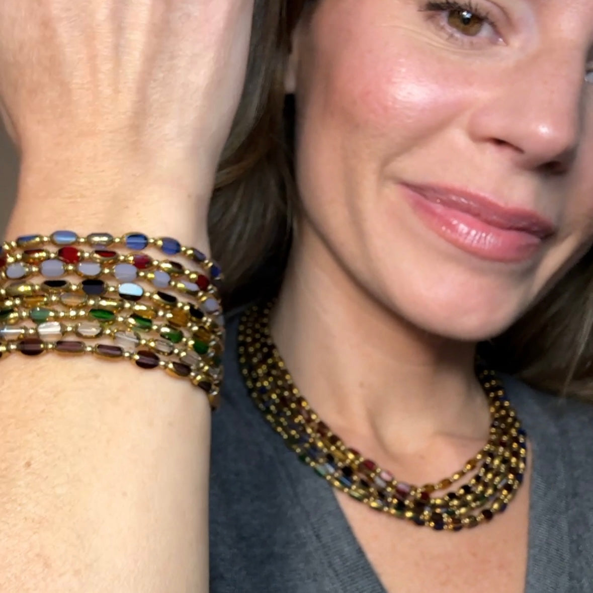 Woman wearing May & Moon's Brio Collection, showcasing stacked Czech glass beaded bracelets in multicolored tones and a matching layered choker with gold accents — handmade, bold, and statement-ready.