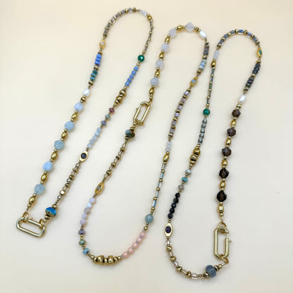 Collection of handmade boho beaded necklaces featuring delicate gemstones, gold accents, and layered minimalist styles by May & Moon