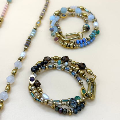 Handcrafted layered boho pastel and smoky beaded necklaces featuring natural gemstones, gold details, and artisan minimalist style by May & Moon